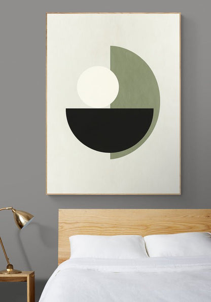 Plakat z geometrycznym motywem koła i półkola w zieleni, czerni i bieli zawieszony nad łóżkiem z drewnianym zagłówkiem w nowoczesnej sypialni